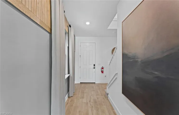 Hall featuring light wood-style floors and recessed lighting