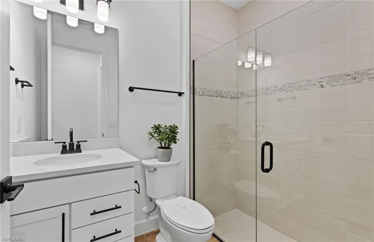 Full bath with vanity and a shower stall