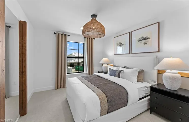 Bedroom with light carpet and baseboards