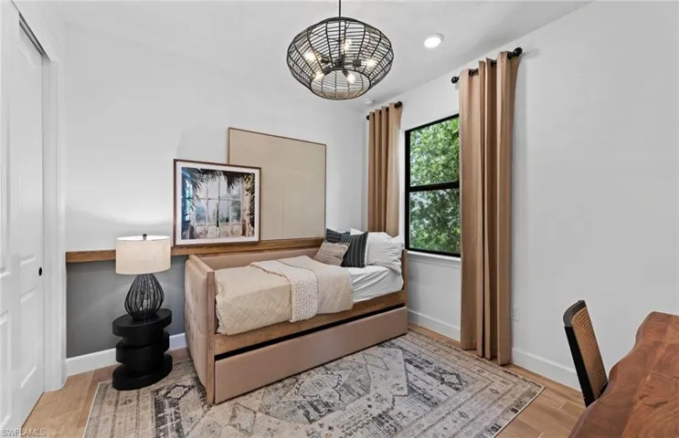 Bedroom with a closet and light wood-style floors