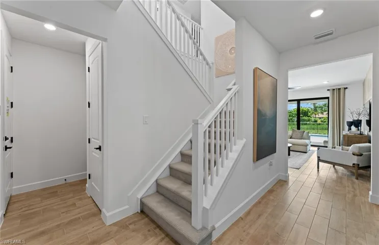 Stairway featuring recessed lighting and wood finished floors