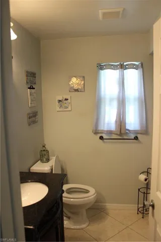 Guest bathroom with vanity and linen closet