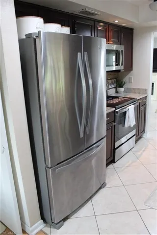 Kitchen featuring stainless steel refrigerator, bottom freezer