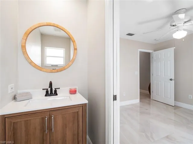 Bathroom featuring vanity and ceiling fan