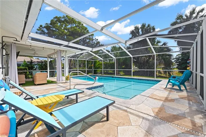 Outdoor pool with a patio area, a lanai, and a sunroom