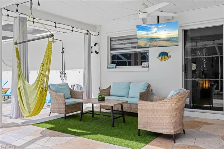 View of patio featuring outdoor furniture, a sunroom, and ceiling fan