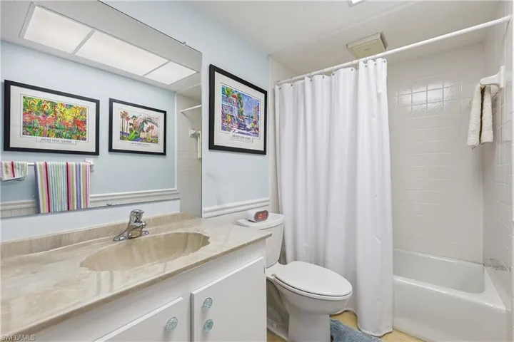 Full bathroom featuring vanity and shower / bathtub combination with curtain
