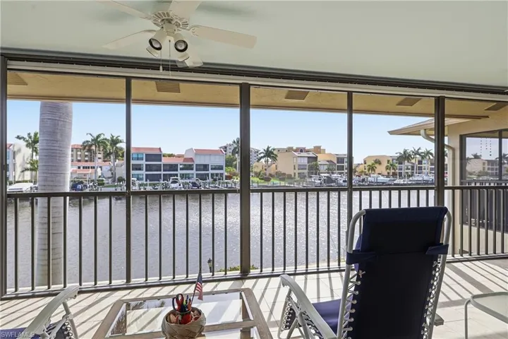Sunroom featuring a water view and a residential view