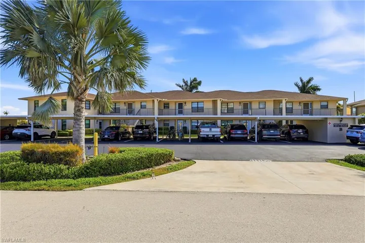 View of building exterior with covered parking
