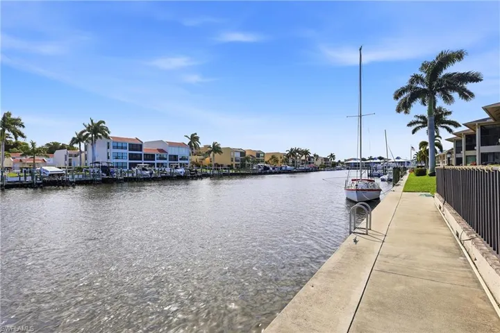 Dock area with a water view and a residential view