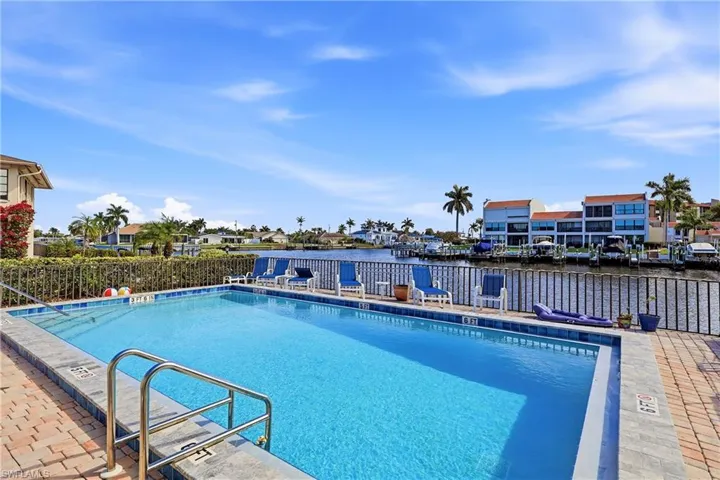 Community pool featuring a residential view and a patio