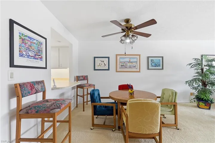 Dining area featuring light carpet and ceiling fan