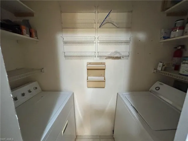 Laundry room with washing machine and clothes dryer