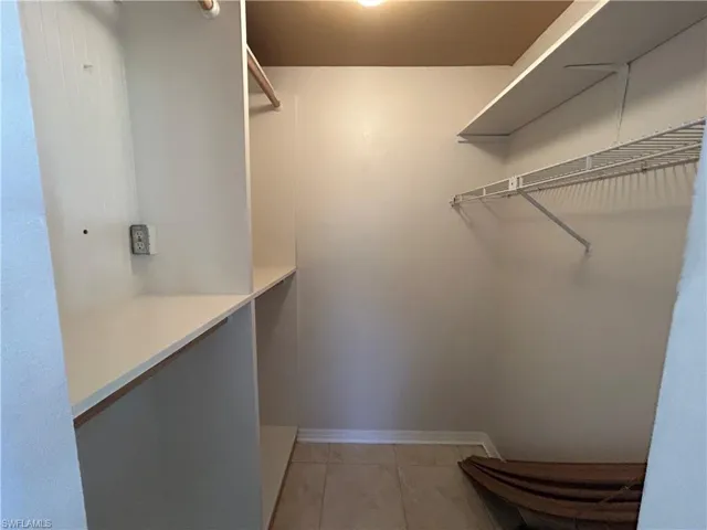 Walk in closet featuring light tile patterned flooring