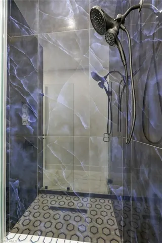 Bathroom featuring a shower with door