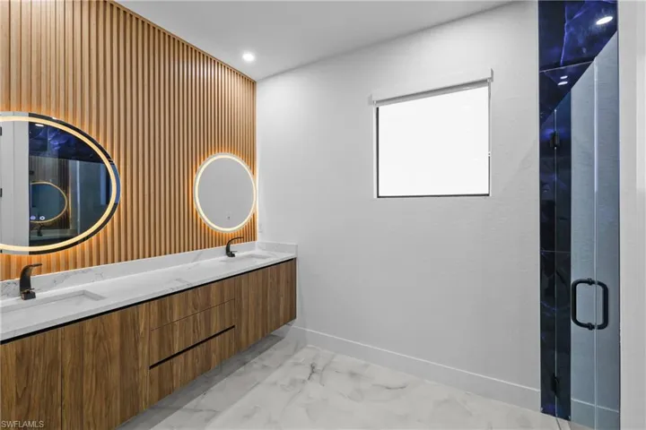 Bathroom with a shower with door and vanity