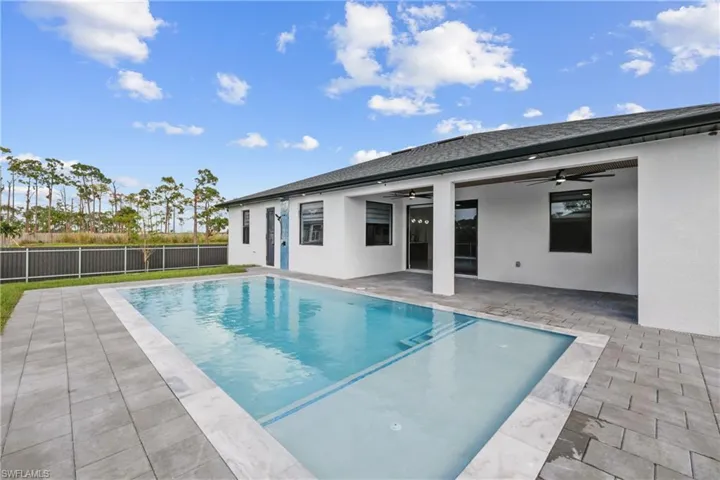 View of pool with a patio and ceiling fan