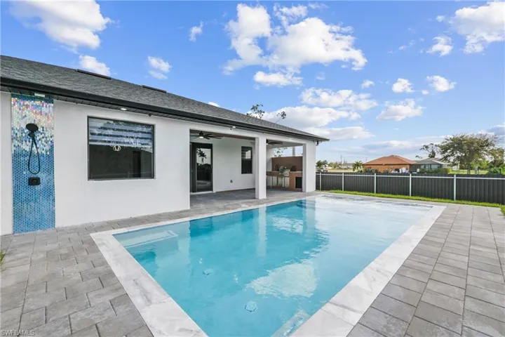 View of pool featuring a patio and ceiling fan