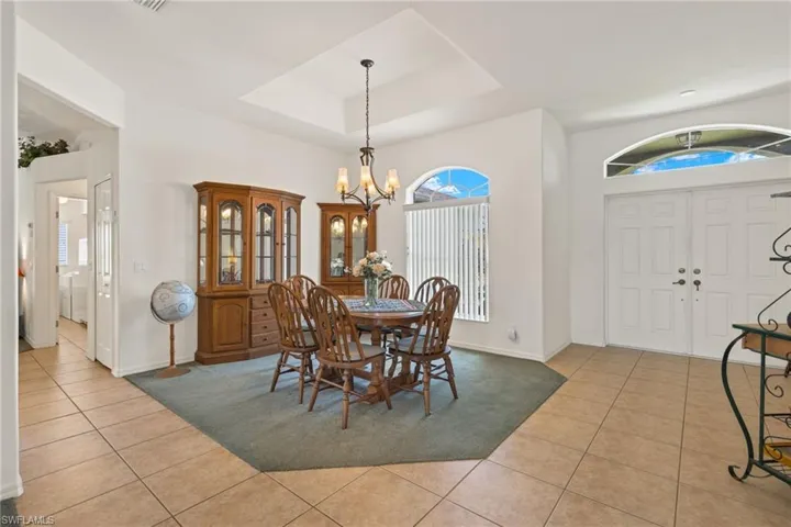 Formal dining next to entry from living area view