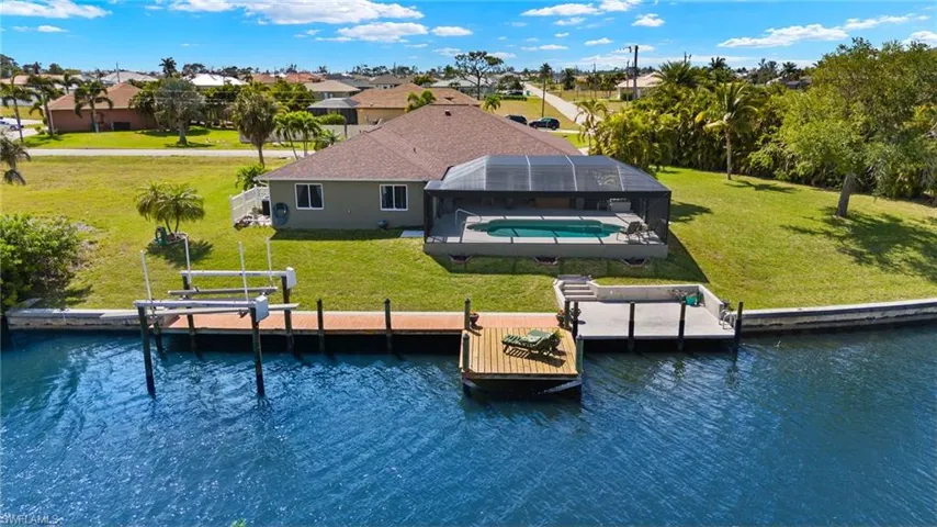 Back of home with seawall and docks