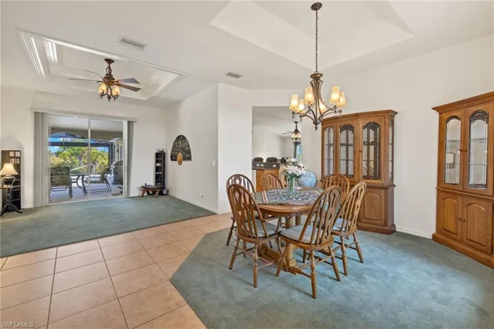 Dining & Living area from front entry.  Entrance to family room/kitchen.  View of screened in lanai.  Primary bedroom is left of entry.