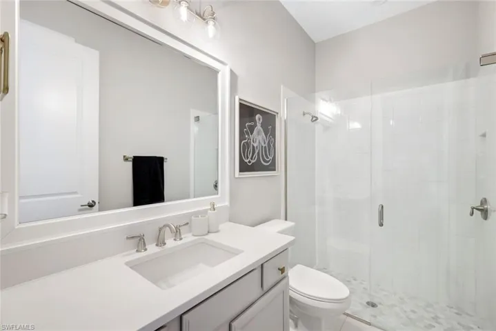 Full bathroom featuring a stall shower and vanity