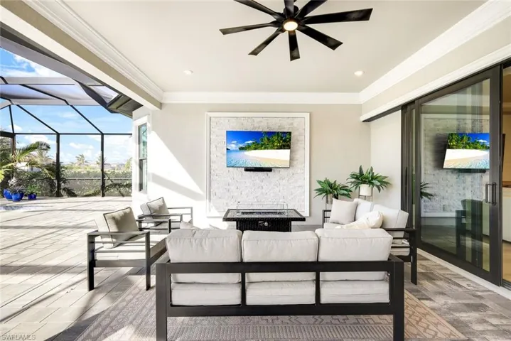 View of patio / terrace featuring a sunroom, glass enclosure, outdoor lounge area, and ceiling fan