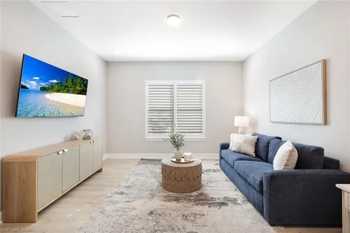 Living room featuring light wood-style floors and baseboards
