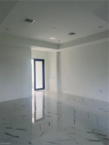Empty room featuring tile floors