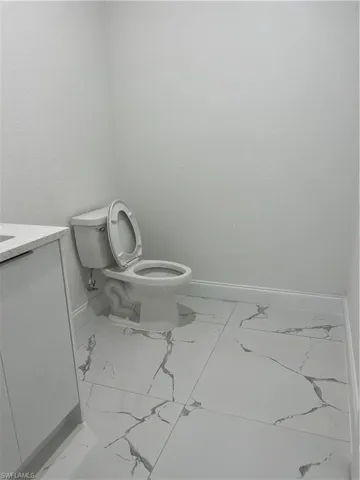 Bathroom with tile floors, toilet, and vanity