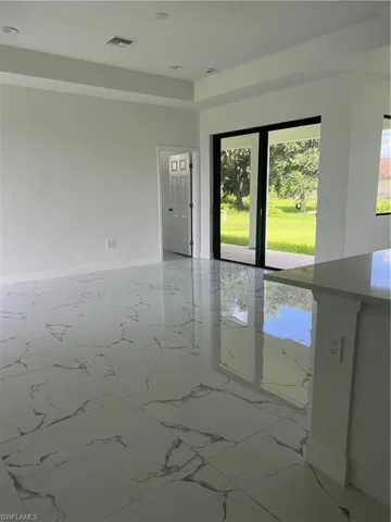 Spare room with light tile floors