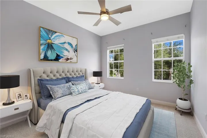 Bedroom with ceiling fan and carpet floors