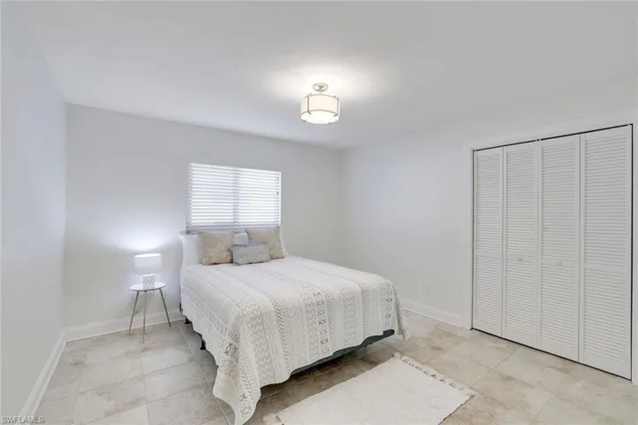 Guest Bedroom with tile floor, and a good size closet.