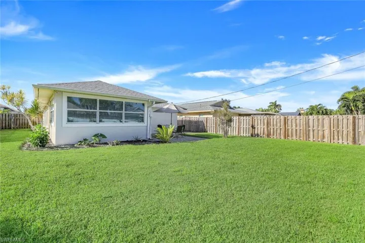 Back of house with a large yard.