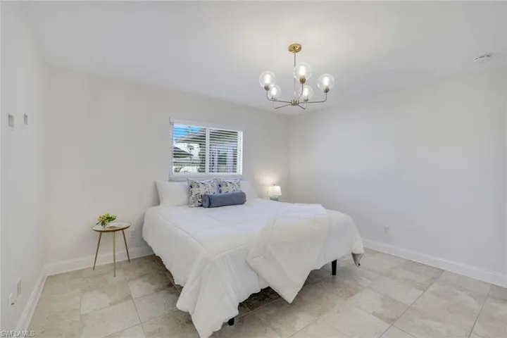 Large Master Bedroom with a notable chandelier. New "sleep number" king bed.