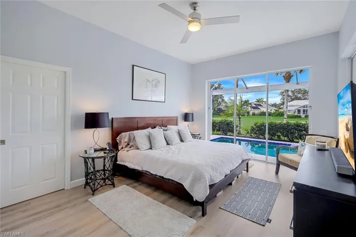Bedroom featuring ceiling fan, light hardwood / wood-style floors, and access to outside