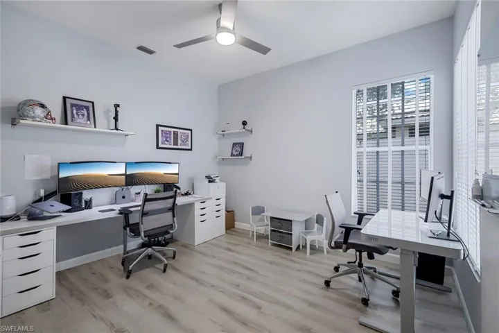 Office space featuring ceiling fan and light hardwood / wood-style flooring