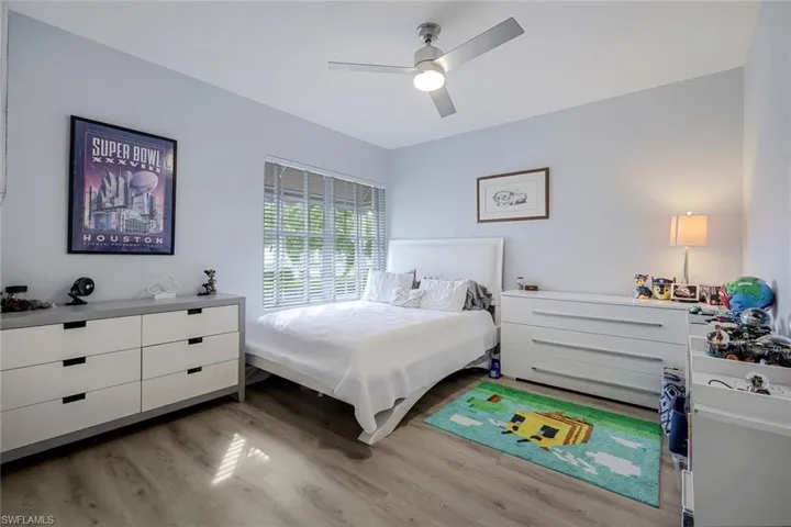 Bedroom with ceiling fan and light wood-type flooring