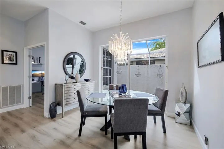 Dining area with a chandelier and light hardwood / wood-style floors