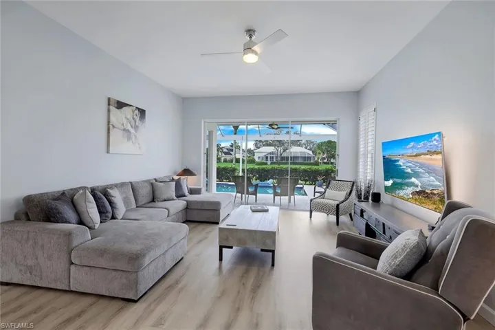 Living room featuring ceiling fan and light hardwood / wood-style flooring