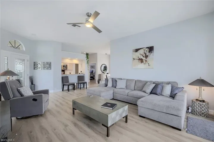 Living room featuring ceiling fan and light wood-type flooring