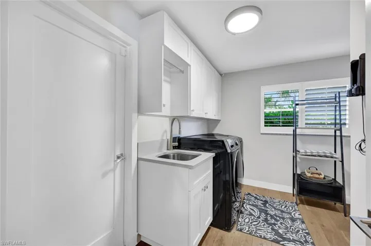 Laundry Room with owners closet sink and cabinets