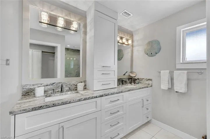 Primary Bath with stone counters and tower of drawers