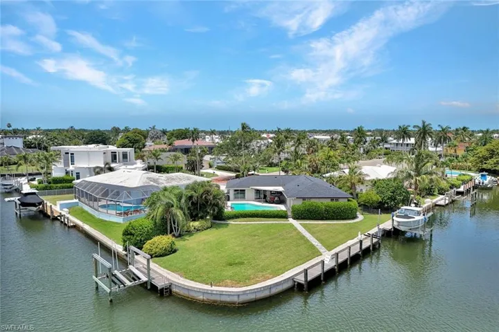 200' of SEAWALL on .37 ACRE TIP LOT with 3 BOAT DOCKS Remodeled Cottage and New Construction Drawings by Falcon Design!!!