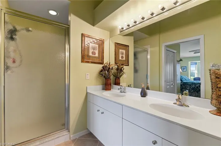 Master bathroom featuring dual vanities and walk-in shower.