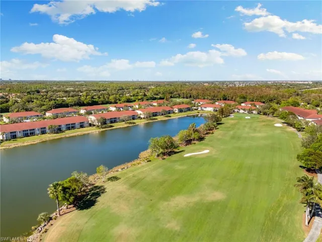 Birds eye view of property with a water view