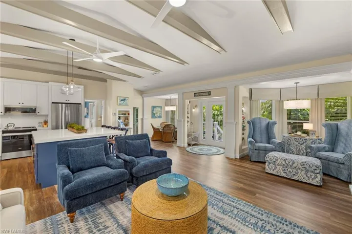 Living area featuring ceiling fan and dark wood-style flooring