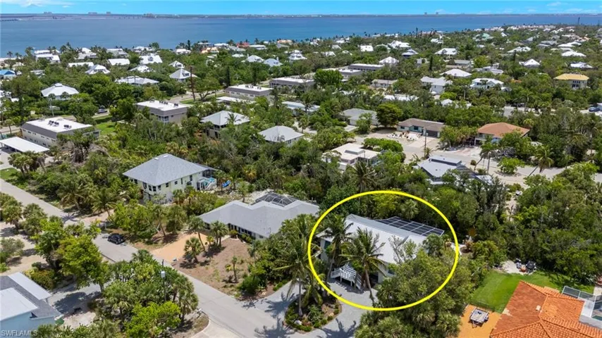 Aerial view of residential area featuring a large body of water