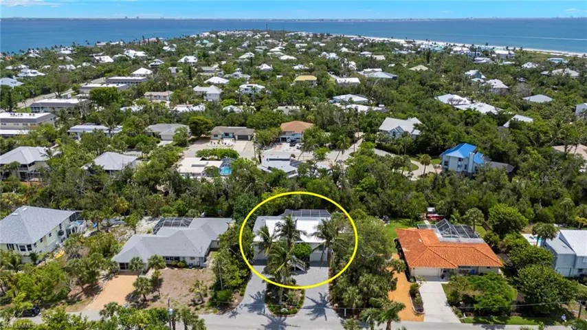 Aerial view of residential area featuring a large body of water