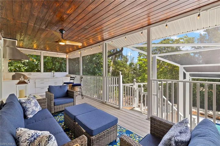 Sunroom with an outdoor living space, exterior kitchen, and a ceiling fan